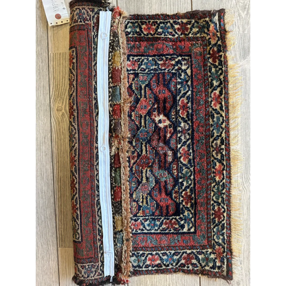 Vintage 1900s Persian hanging rug with intricate floral and geometric patterns in reds and blues