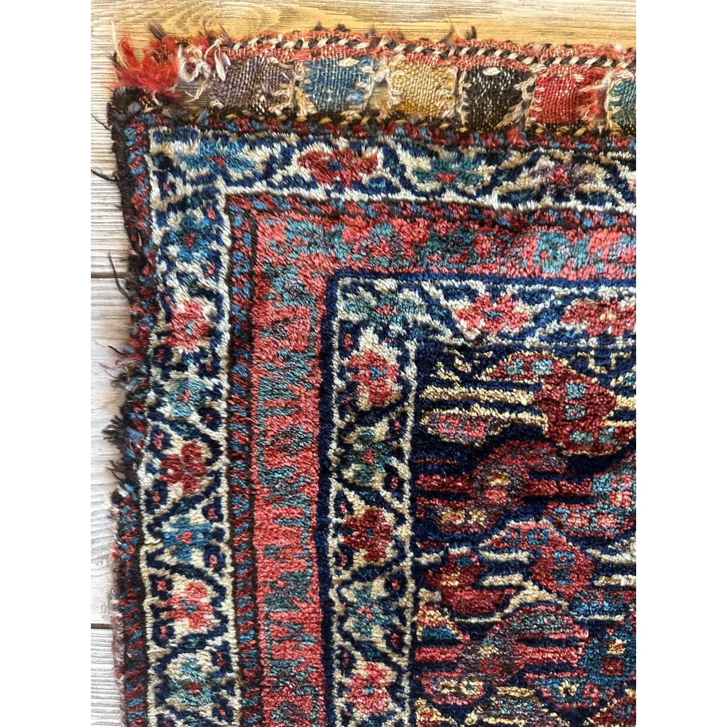 Vibrant 1900s Persian hanging rug, red and blue ground with intricate floral patterns, natural wool