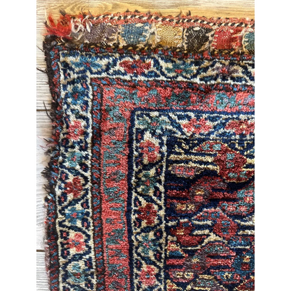 Vibrant 1900s Persian hanging rug, red and blue ground with intricate floral patterns, natural wool