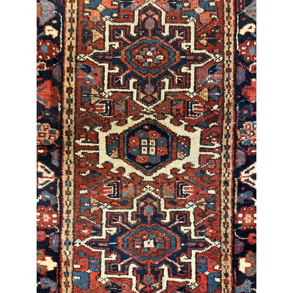Stunning 1900s Persian Karaja rug with intricate geometric floral patterns in deep red navy blue and cream wool