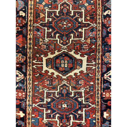 Stunning 1900s Persian Karaja rug with intricate geometric floral patterns in deep red navy blue and cream wool