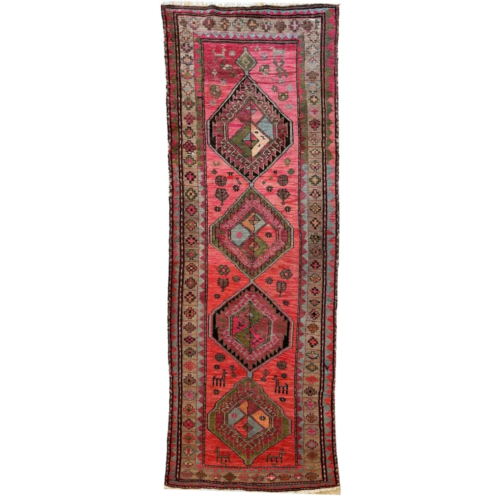 1910s Caucasian runner rug, vibrant natural dyes, pink red geometric patterns with authentic abrash