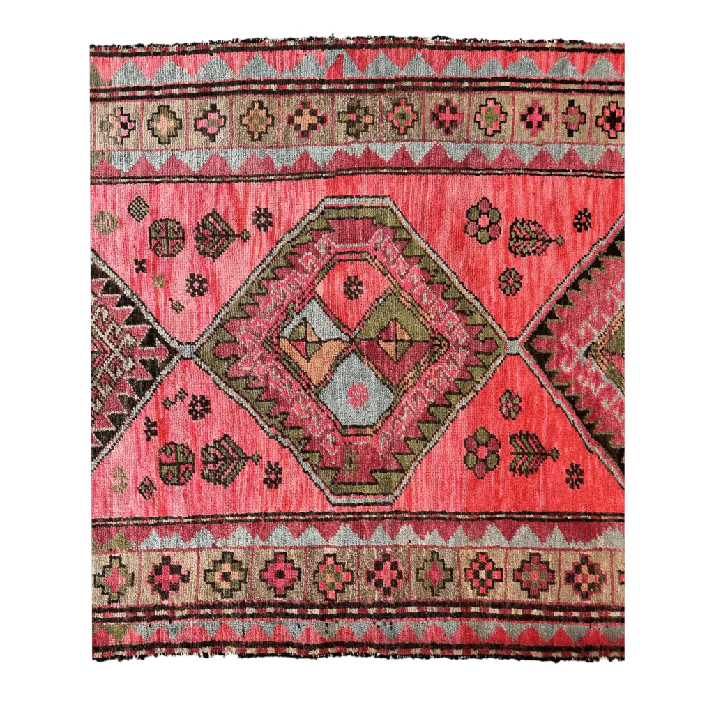 Antique Caucasian runner 1910s, close-up of vibrant pink geometric floral patterns, natural dyes