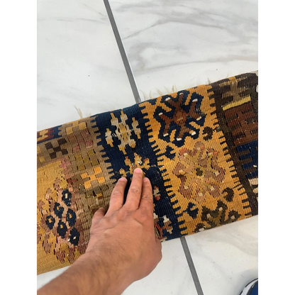 Hand on stunning 1920s antique Anatolian wool prayer rug with intricate patterns