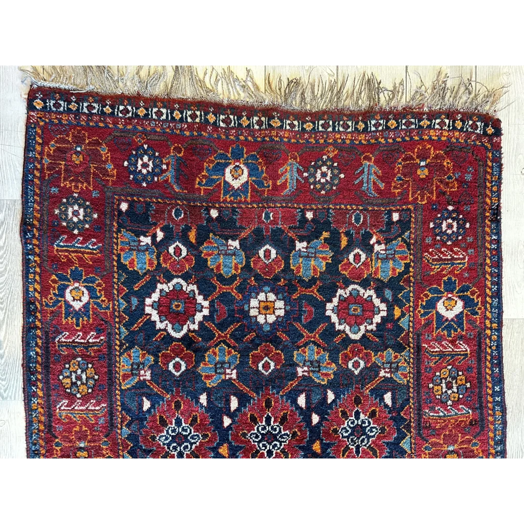 Antique Khamseh Persian rug 1920s, close-up of geometric floral design and natural dye colors