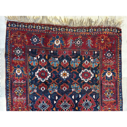Antique Khamseh Persian rug 1920s, close-up of geometric floral design and natural dye colors