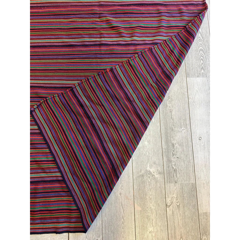 Vibrant 1920s antique Persian square rug with bold stripes on wood floor