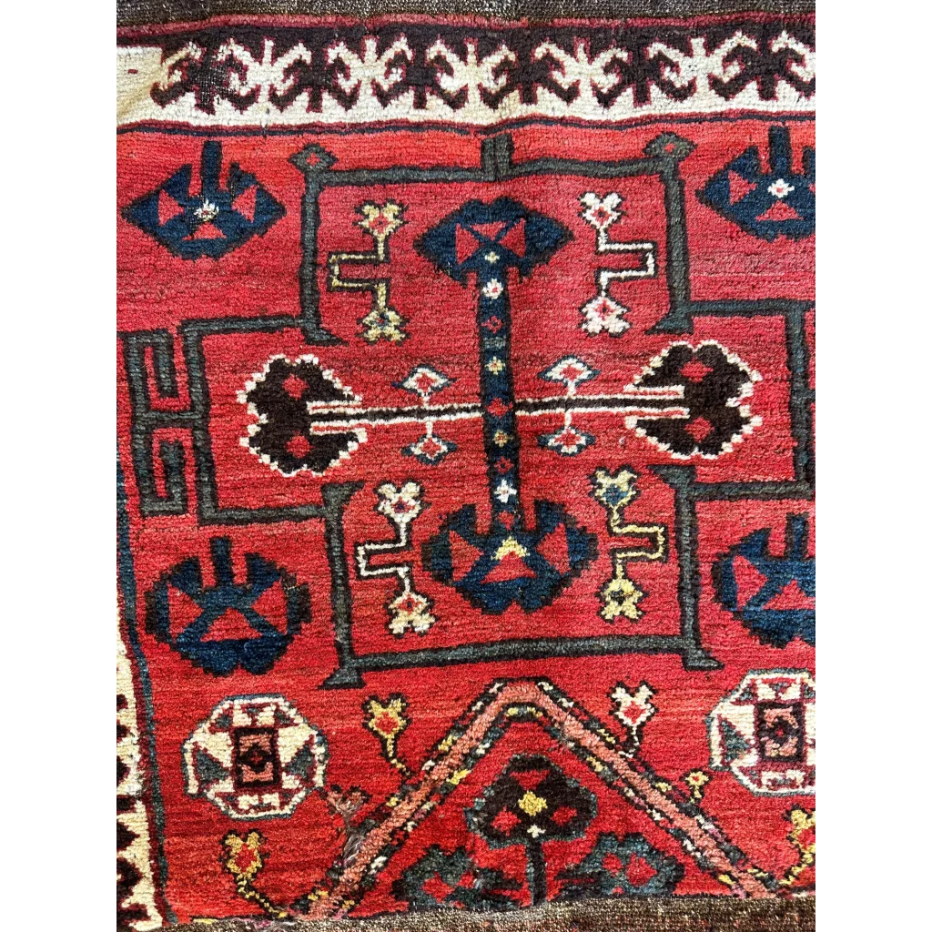 Vintage 1950s Persian tribal bagface rug with geometric floral patterns in natural wool