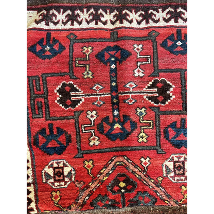 Vintage 1950s Persian tribal bagface rug with geometric floral patterns in natural wool
