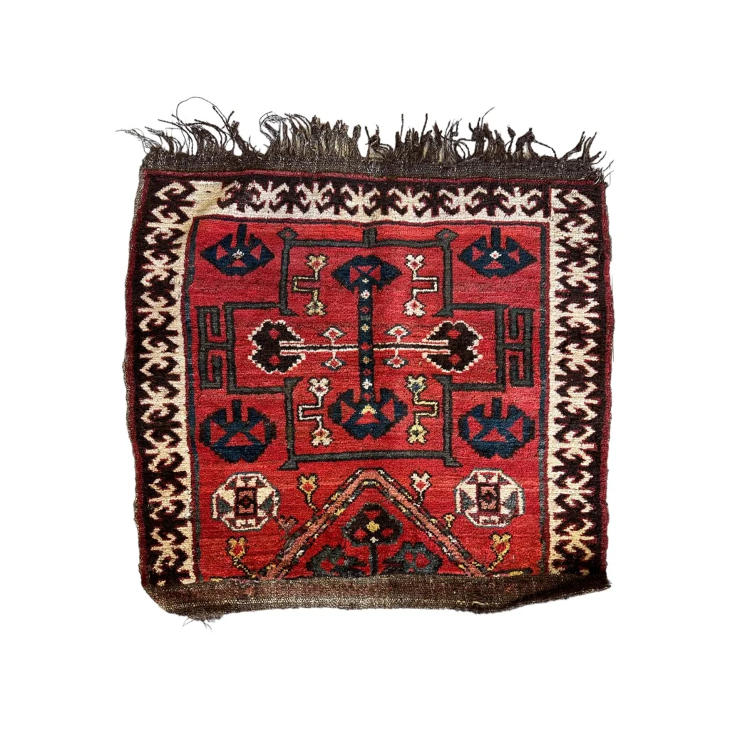Vintage 1950s Persian tribal bagface with natural wool pile and geometric floral patterns