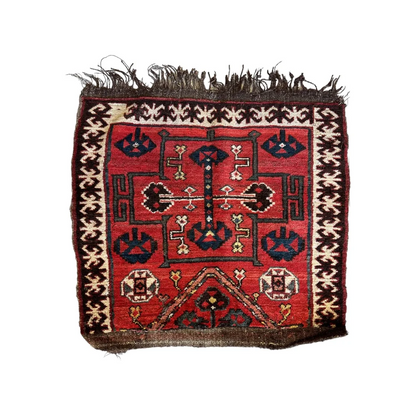 Vintage 1950s Persian tribal bagface with natural wool pile and geometric floral patterns