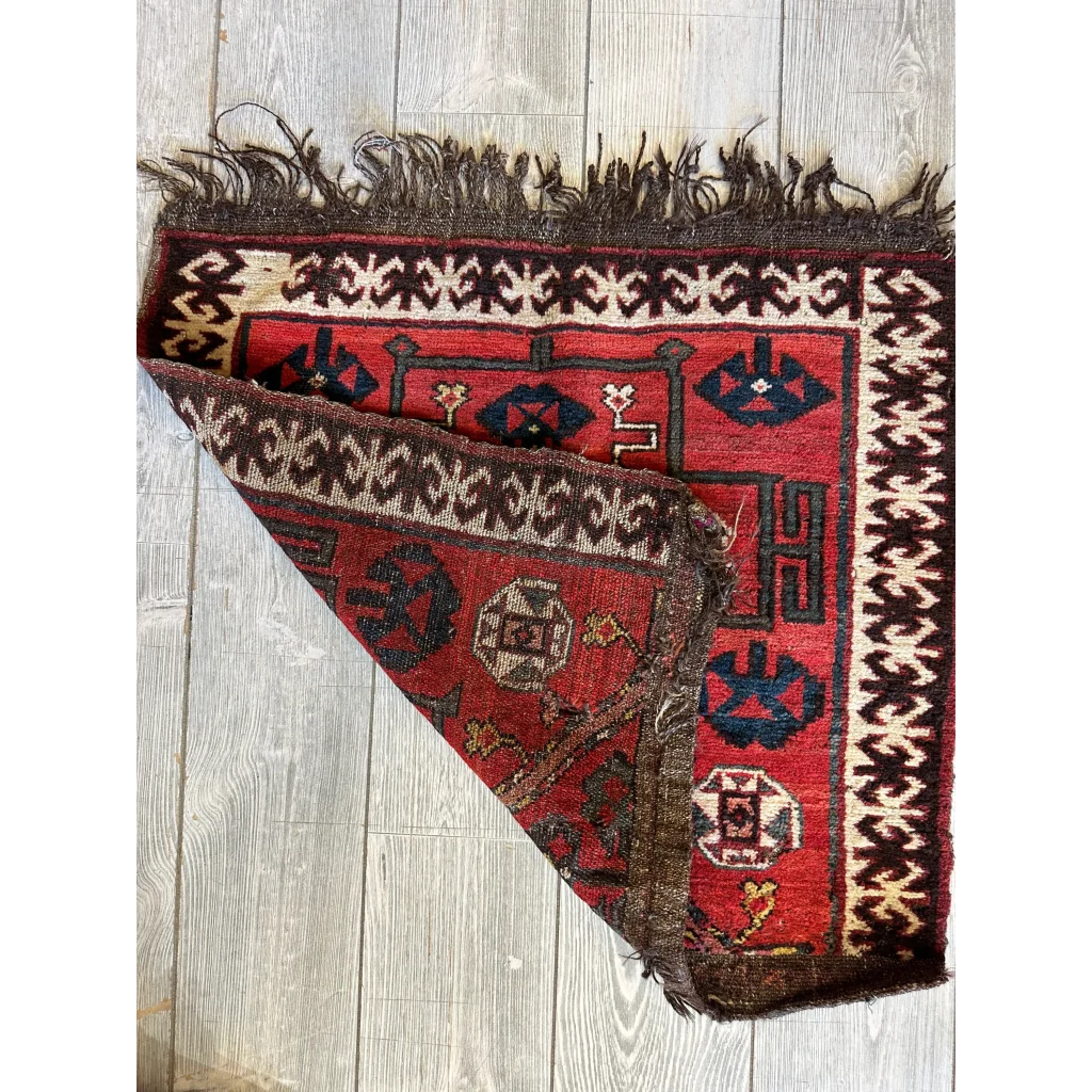 Vintage 1950s Persian tribal bagface with geometric patterns in natural wool