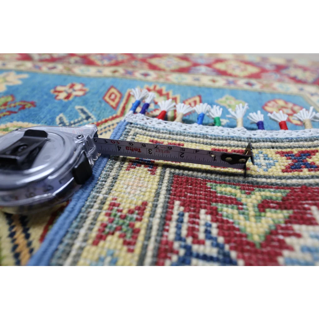 Silver and black tape measure on Stunning Afghan Kazak Runner with cotton foundation