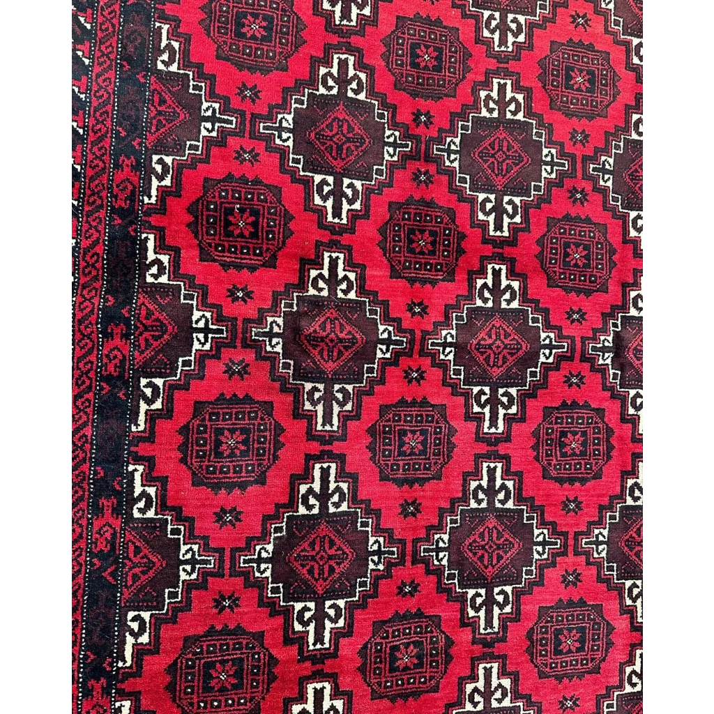 Vibrant red Afghani Baluch hand-knotted wool rug with intricate geometric patterns