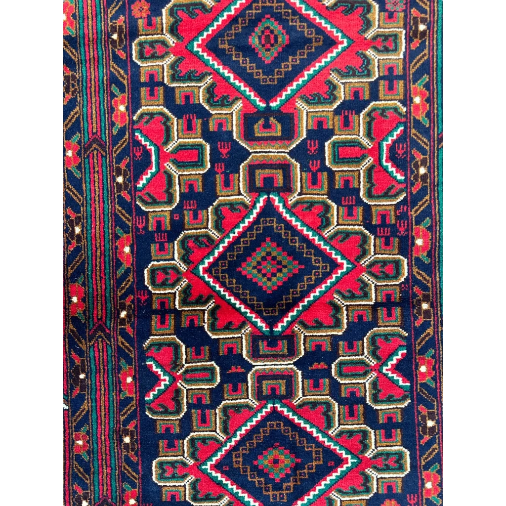 Vibrant Afghani Baluch wool rug with red navy geometric diamonds for small spaces