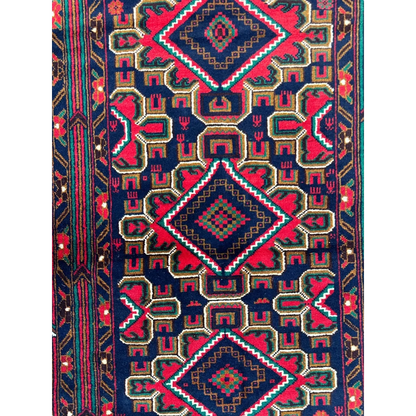 Vibrant Afghani Baluch wool rug with red navy geometric diamonds for small spaces