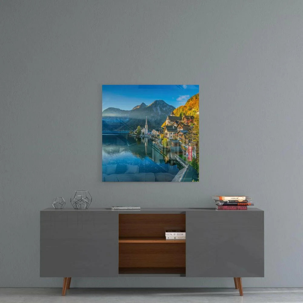 Serene alpine village glass wall art with lake reflection