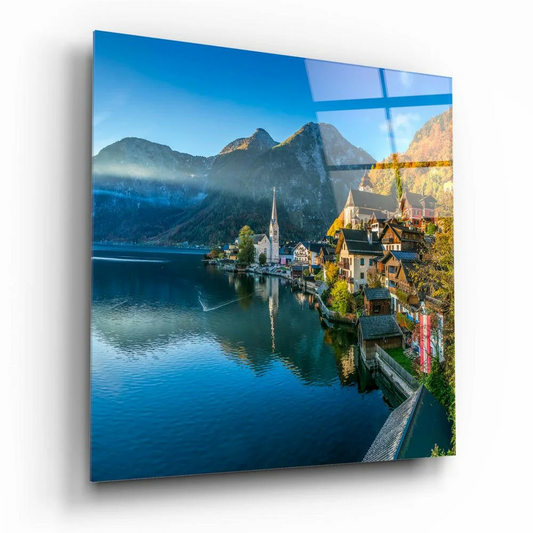 Vibrant square glass wall art of alpine village and blue mountain lake
