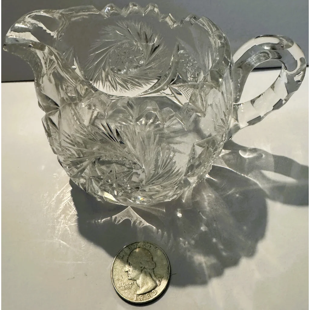 American brilliant cut glass creamer with scalloped rim and ornate faceted design