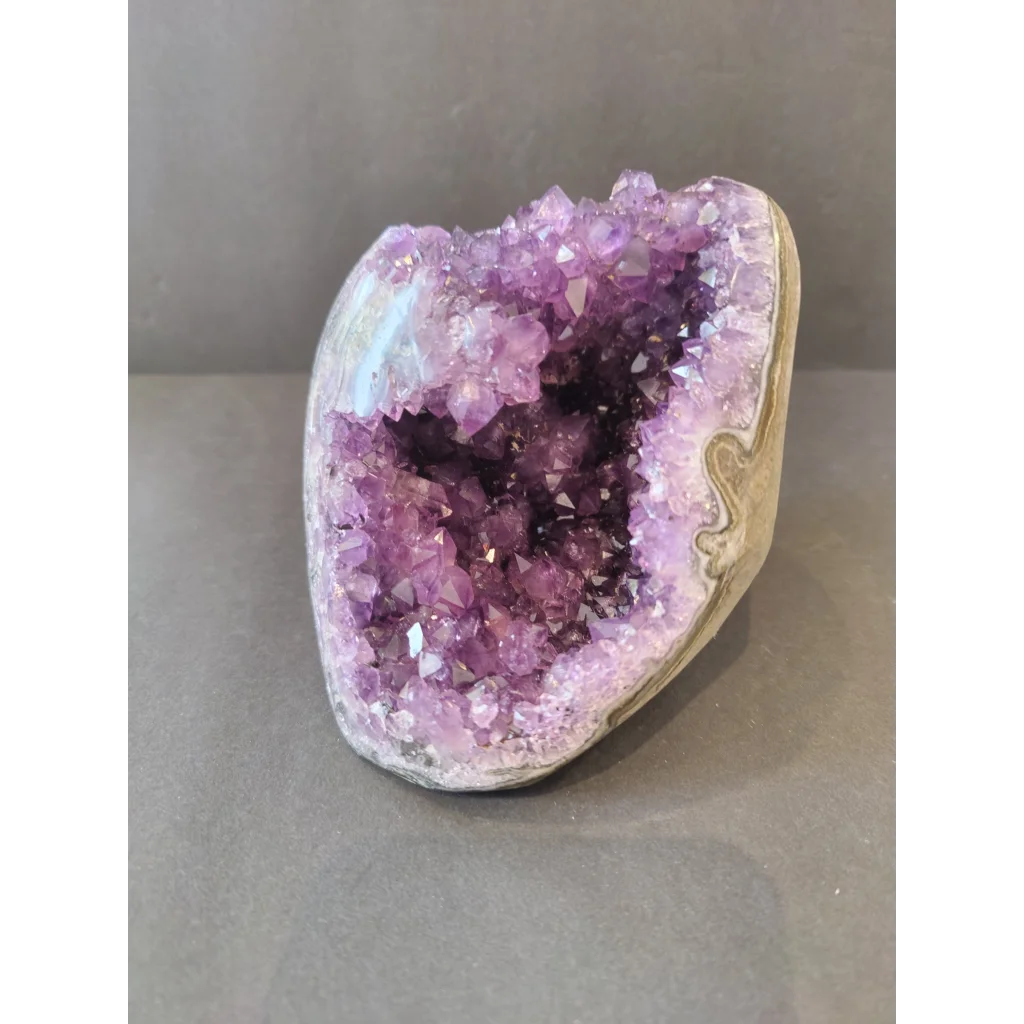Stunning purple amethyst geode with natural stalactite formation