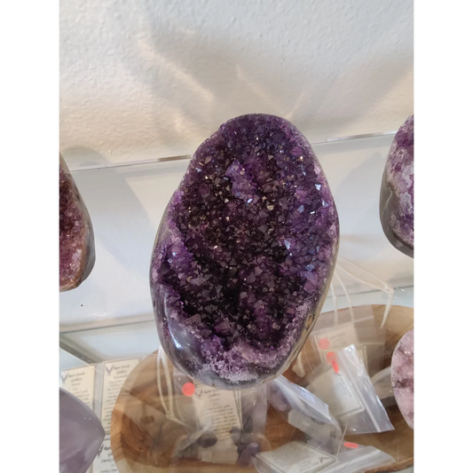 Stunning amethyst geode sculpture with sparkling purple crystals