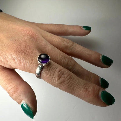 Sleek silver amethyst ring with round deep purple gem in minimalist band