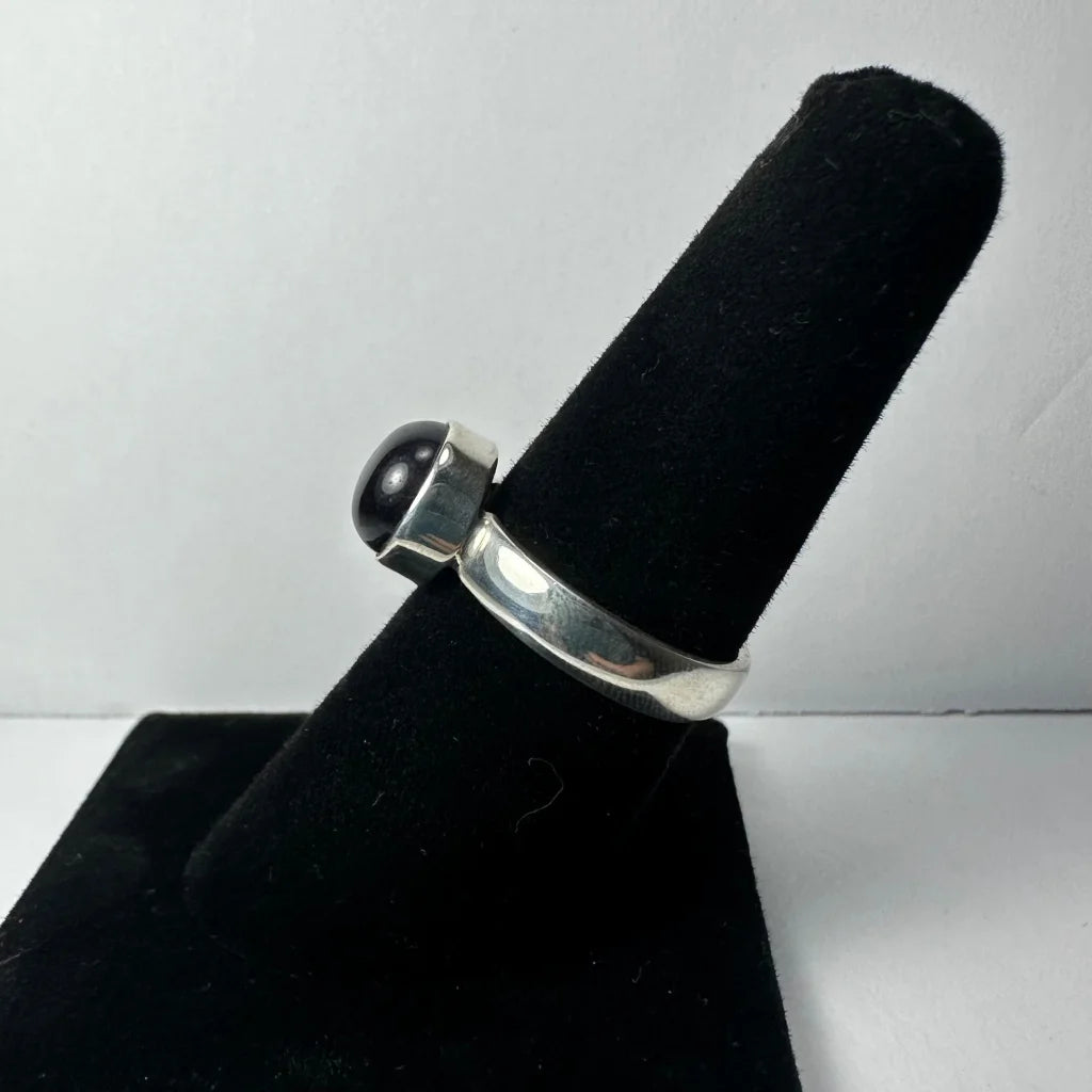 Sleek silver amethyst ring with smooth rounded black onyx stone