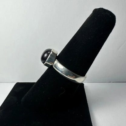 Sleek silver amethyst ring with smooth rounded black onyx stone