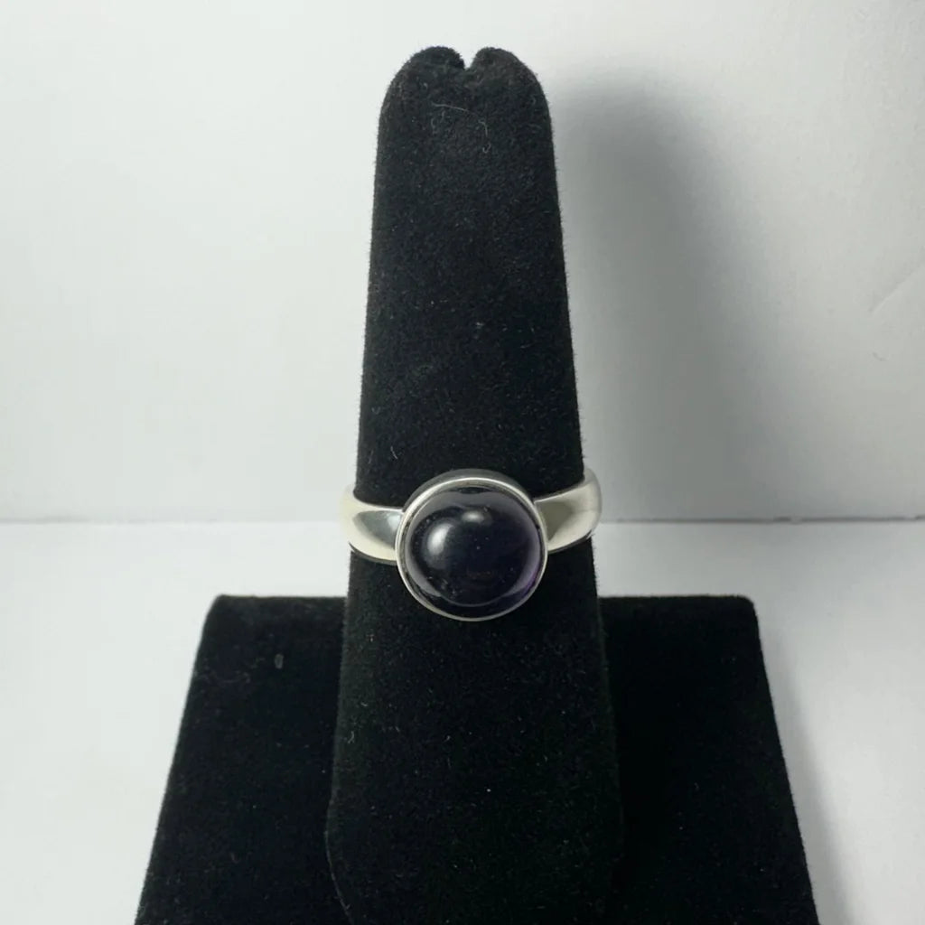 Stunning amethyst ring in sleek silver band with smooth round black onyx stone