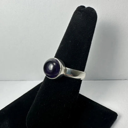 Sleek silver amethyst ring with smooth deep purple cabochon stone