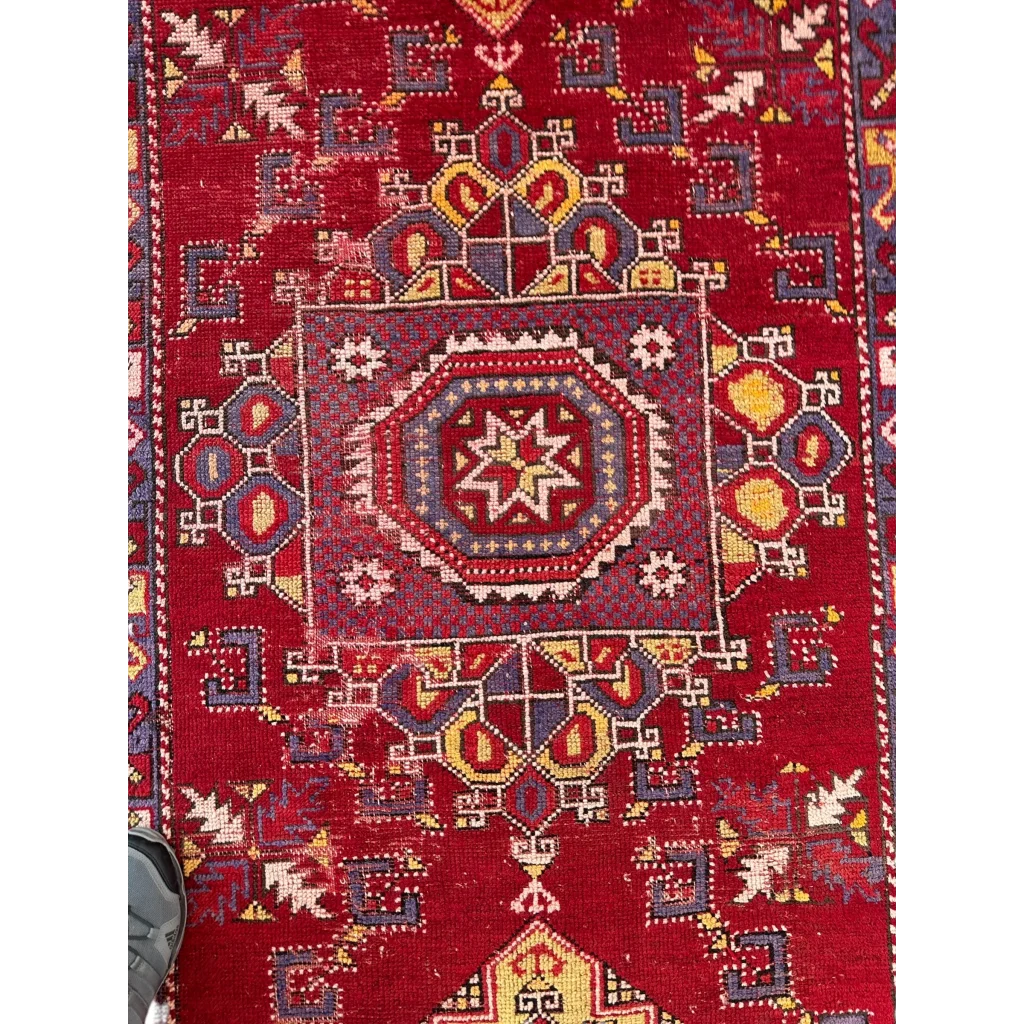 Vibrant red Anatolian tribal rug with bold medallion and floral patterns