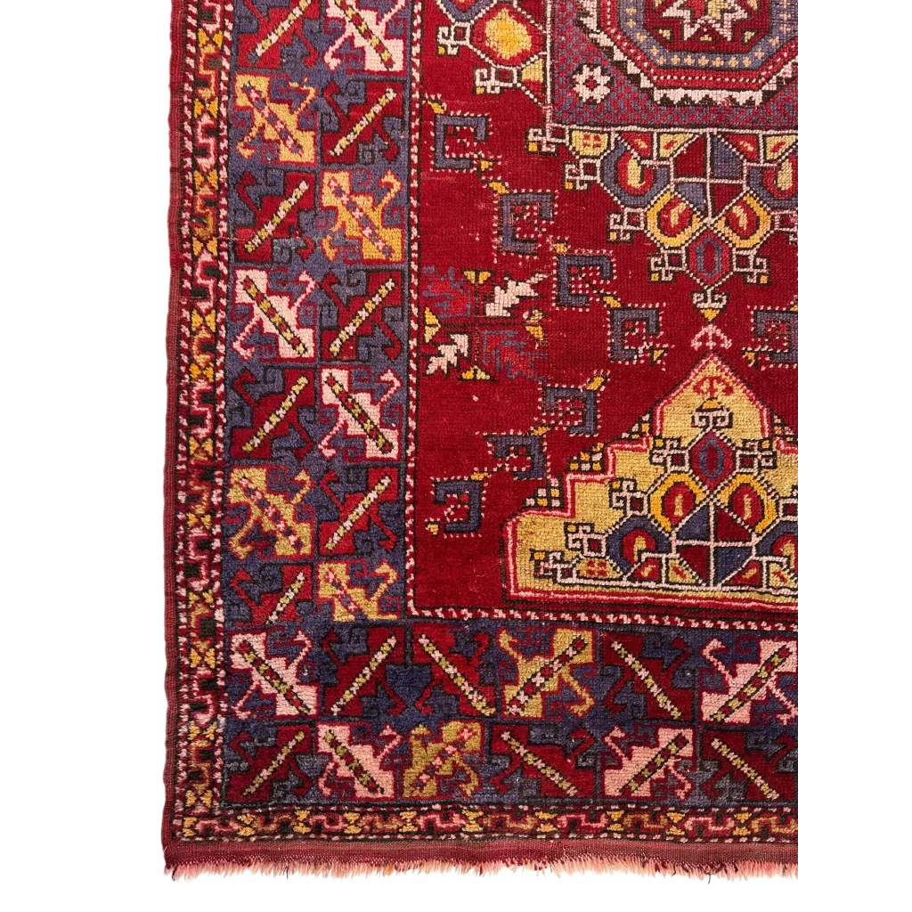Vibrant Anatolian tribal rug in bold red medallion with geometric floral patterns