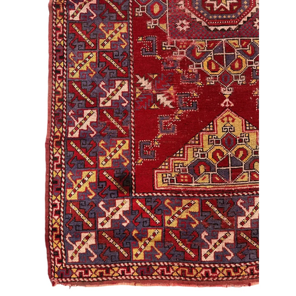 Vibrant Anatolian tribal rug with bold red medallion and intricate patterns