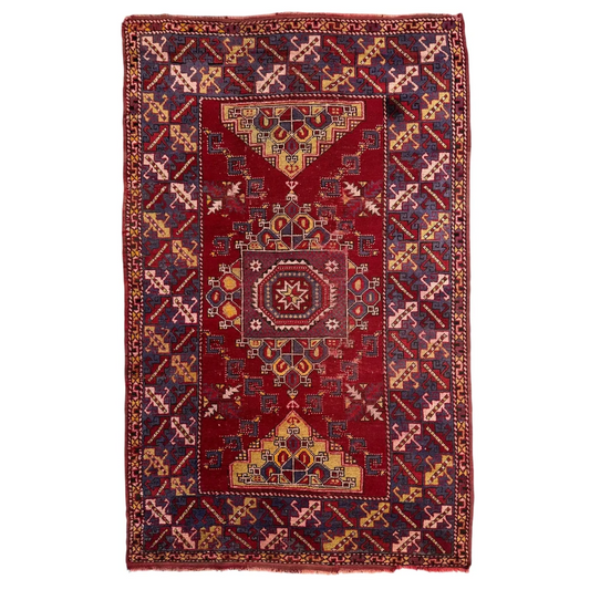 Stunning Anatolian tribal rug with bold red medallion and geometric motifs