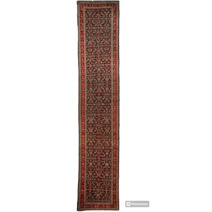 Stunning antique Caucasian wool runner rug in deep reds and florals