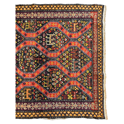 Antique Kazak rug 1910s Caucasus, close-up of bold geometric motifs in red and black natural dyes