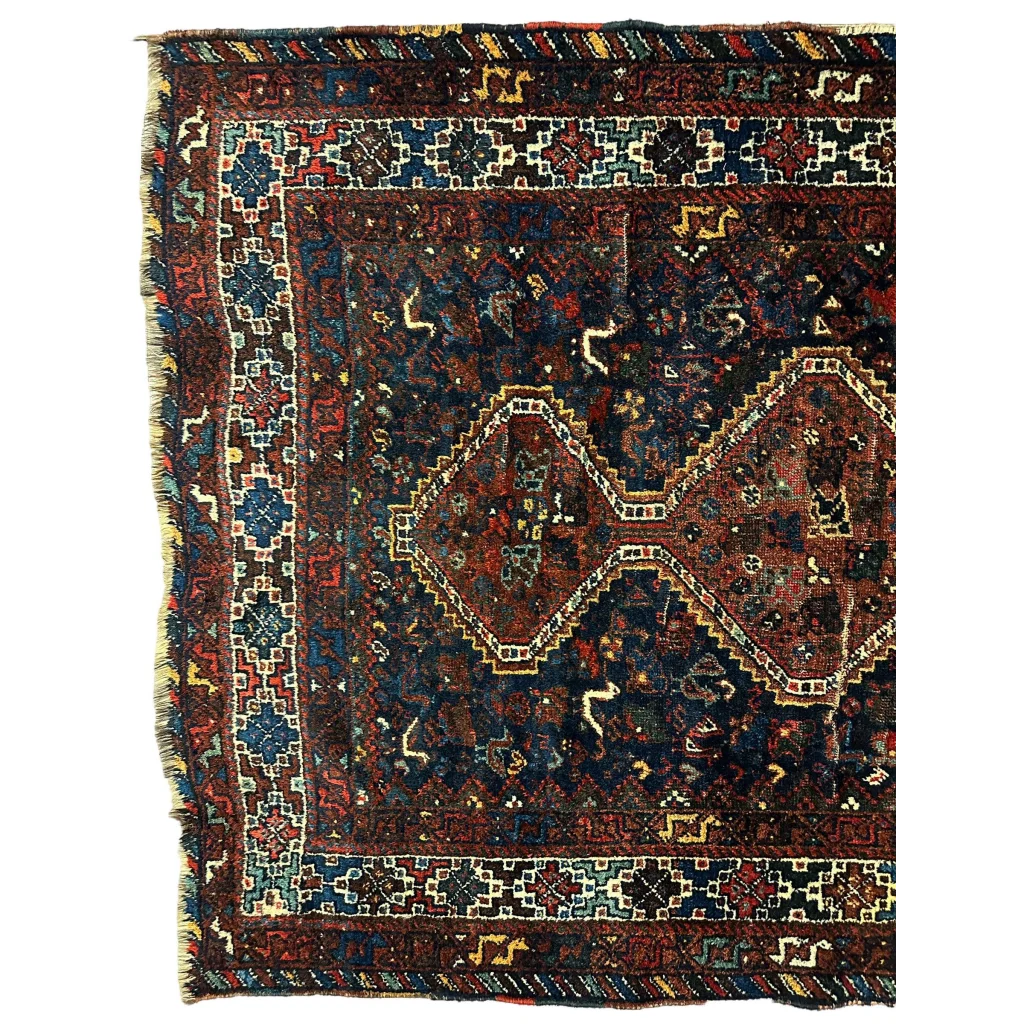 Antique 1920s Persian Khamseh tribal rug with intricate geometric floral patterns in burgundy, navy and cream