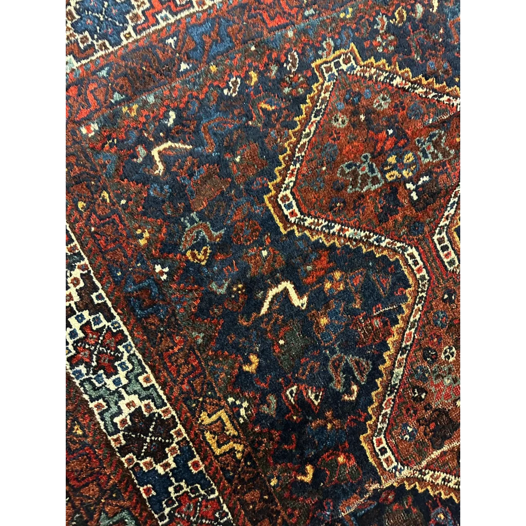 Antique 1920s Persian Khamseh rug with red, navy and gold geometric patterns