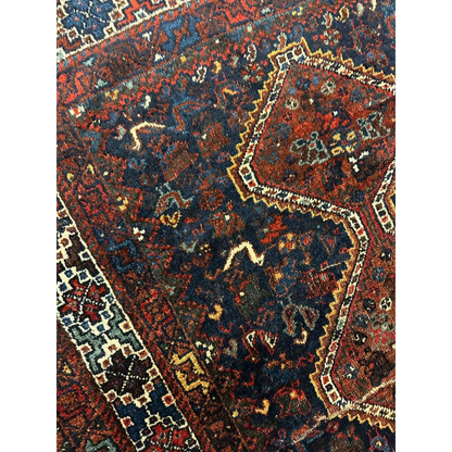 Antique 1920s Persian Khamseh rug with red, navy and gold geometric patterns