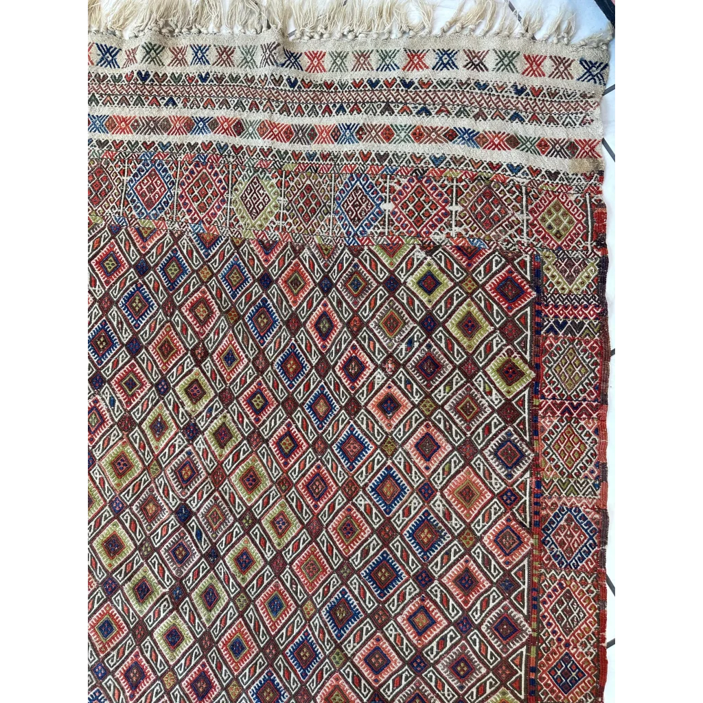 Stunning antique Turkish Jajim wool rug with intricate geometric patterns in earthy red, brown, and blue tones