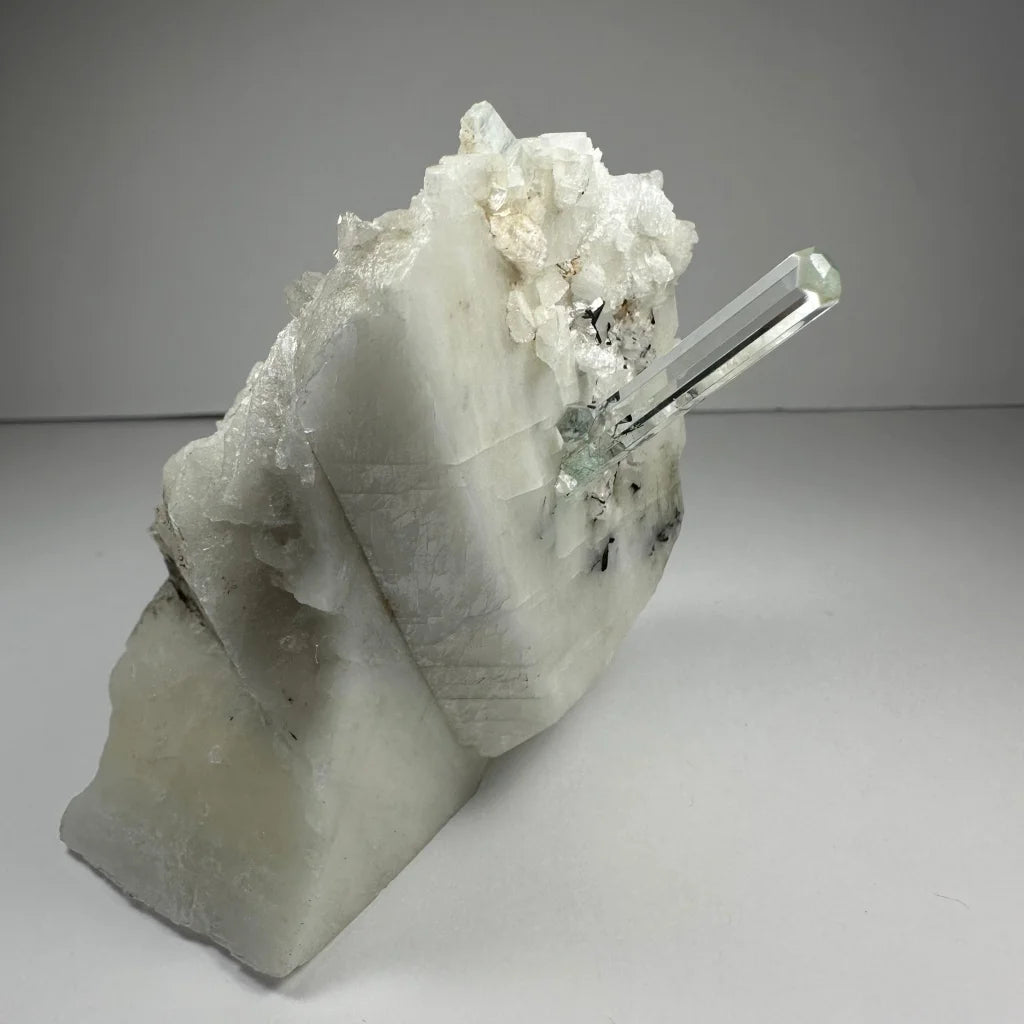 Stunning aquamarine beryl crystal with clear quartz point on albite
