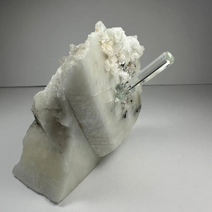 Stunning aquamarine beryl crystal with clear quartz point on albite