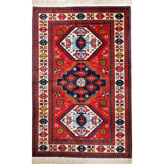 Vibrant red Armenian wool rug with bold geometric design in navy, cream, gold