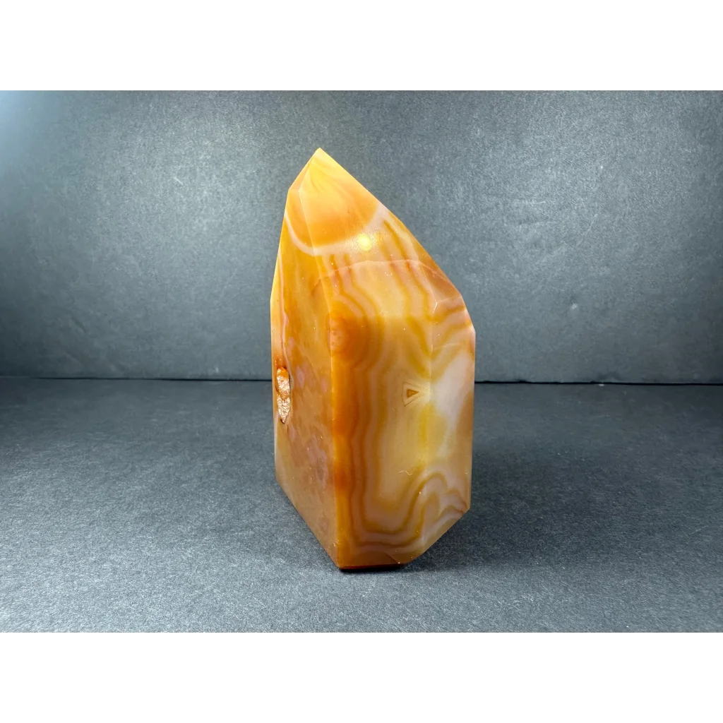 Polished banded carnelian tower from Brazil with wavy agate patterns