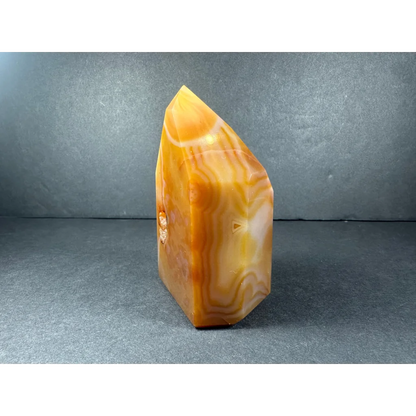 Polished banded carnelian tower from Brazil with wavy agate patterns