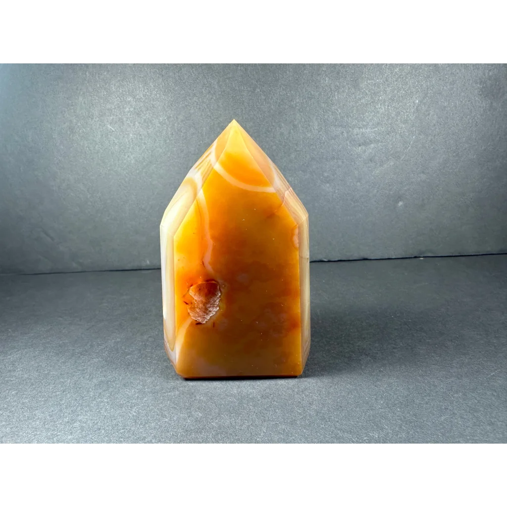 Polished banded carnelian tower from Brazil with swirling patterns