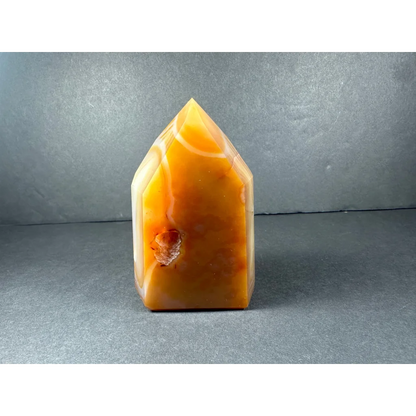 Polished banded carnelian tower from Brazil with swirling patterns