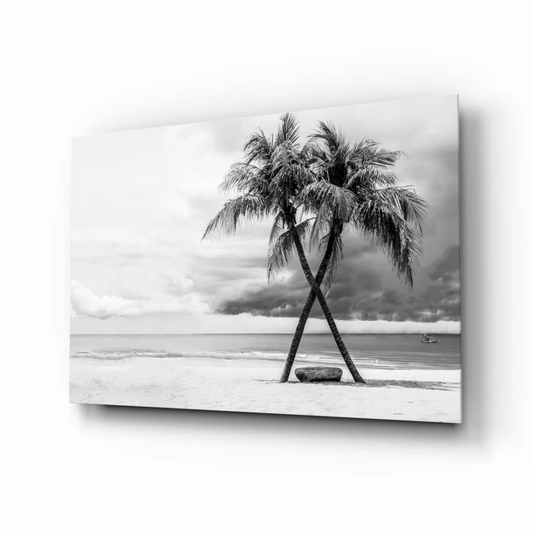 Black-and-white framed beach scene glass wall art with crossed palm trees