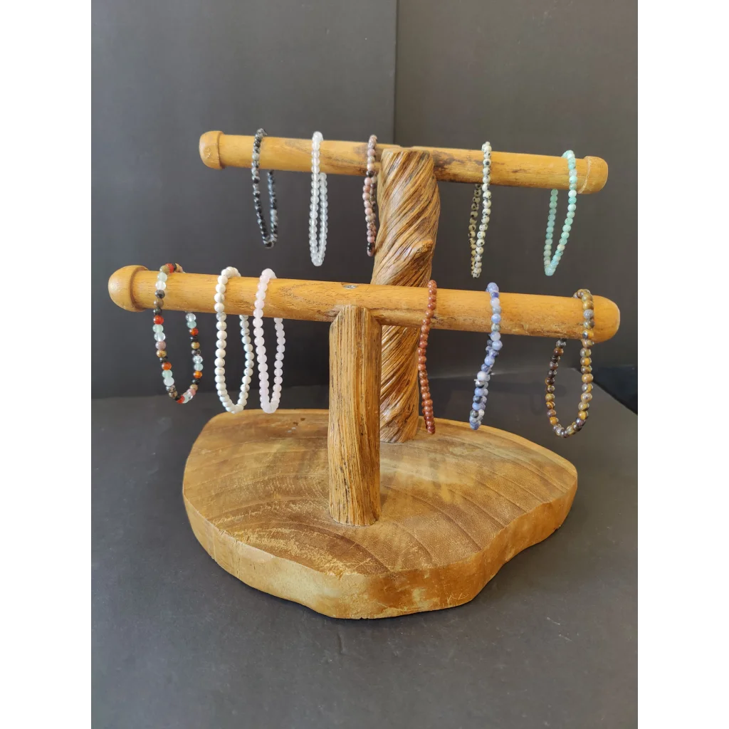 Natural wood stand with bars displaying beaded stone bracelet 4mm gems