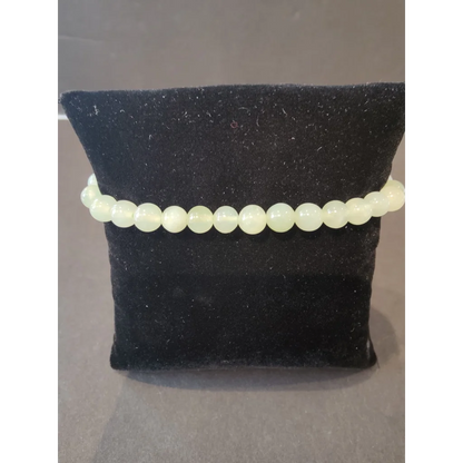 Delicate pale green 6mm beaded stone bracelet of smooth natural gems